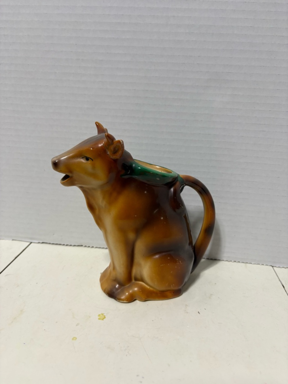 Brown Ceramic Cow Pitcher - One ear has been glued. Has some wear on the sides